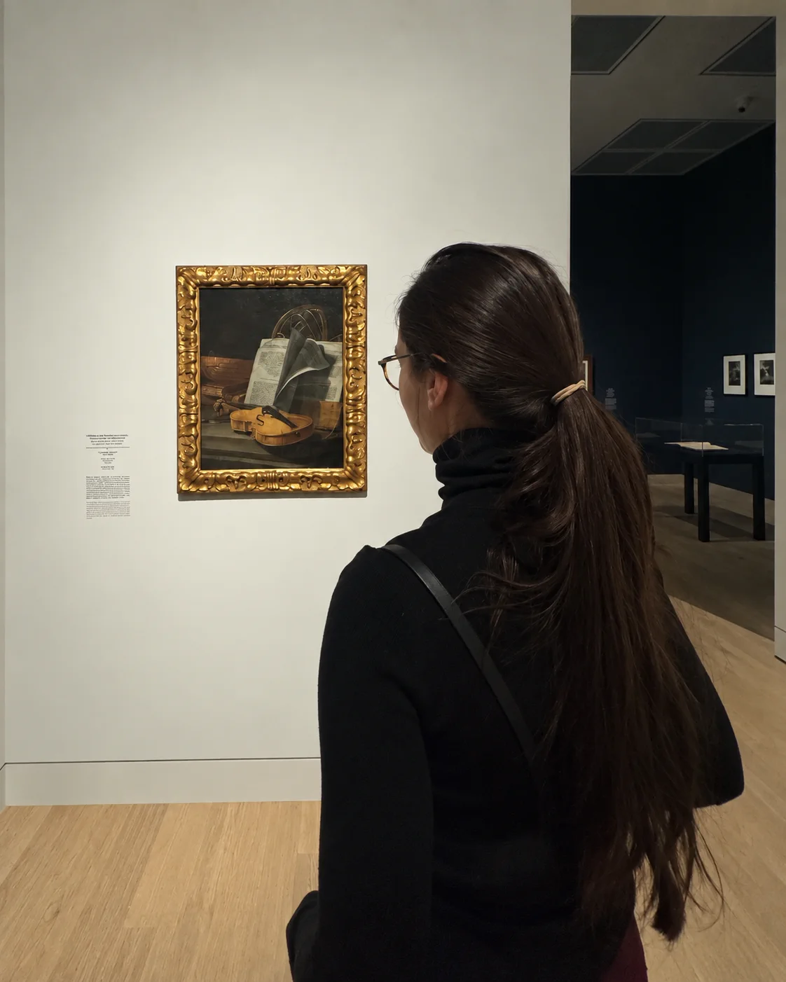 Nina viewing a painting in a museum
